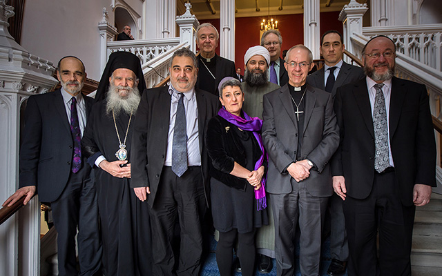 Group photo of religious leaders and representatives from various faiths standing together on a staircase.